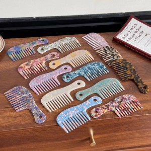 Elegant long-handled acetate wide-tooth hair combs in thirteen assorted marble patterns