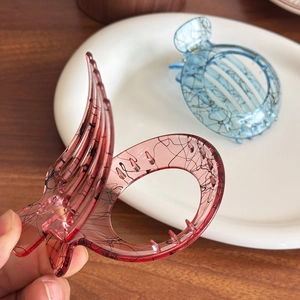 Elegant ink-style hair claw clips in translucent pink and blue with marble line patterns
