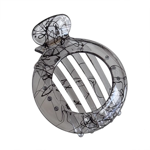 Minimalist circular hair claw clip in translucent grey with black abstract ink lines