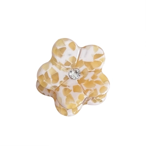 Elegant acetate mini flower hair claw clip with amber texture and center zircon accent