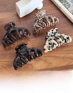 Detail of four large octopus hair claws in leopard, tortoiseshell, and marble patterns