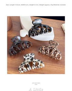 Detail view of 10.8cm acetate hair claws in leopard and amber patterns with dimensions