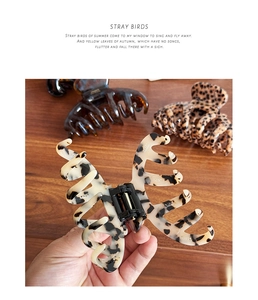 Detailed view of high-quality large acetate hair claw clips in tortoise and leopard patterns