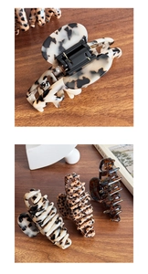 Close-up of leopard print and tortoiseshell acetate hair claws with premium metal spring