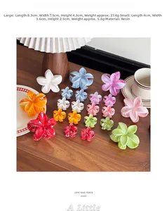 Macro detail of various colorful resin plumeria hair clips on a dark wooden tabletop