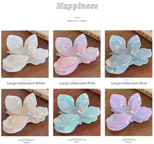 Iridescent flower-shaped hair claws in six colors with rhinestone centers on wood