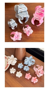 Detail of marble pattern plumeria flower hair claw clip with colorful acetate texture
