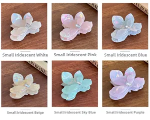 Detail view of colorful small flower hair claws with iridescent finish and rhinestones