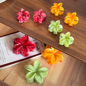 Elegant floral hair claw clips with ink wash marble texture in red orange and green