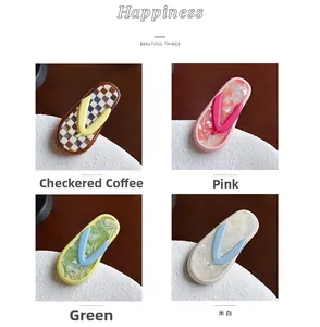 Detail showing acetate hair clips in colorful patterns like marble and plaid check