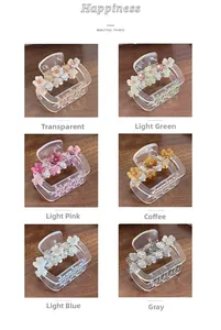 Six couleurs de pinces à cheveux florales avec strass sur une table en bois foncé