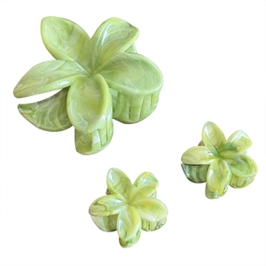 Three-piece green ink marble flower hair claw clips set in various sizes with white background