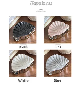 Shell-shaped hair claws in four colors featuring glossy resin and silver metal base