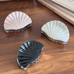 Elegant shell-shaped hair claws in pink, white, and black with silver metal comb teeth