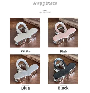 Detail view of heart-shaped hair claws in white pink blue and black colors