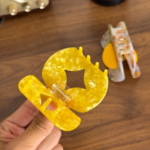 Elegant yellow marbled acetate hair claw clip with golden metal spring for thick hair