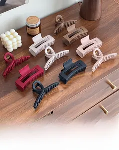 Close-up of matte silicone shark hair claws in assorted neutral colors and shapes