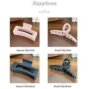 Detail of matte silicone hair claws in rectangular and twisted shapes, pink and black