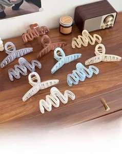 Close-up of assorted translucent jelly large hair claws displayed on a rustic wood surface