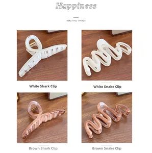 Detailed comparison of translucent jelly resin shark and wave hair clips in white and amber