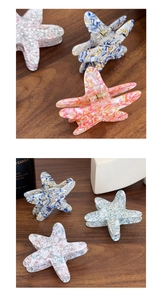 Close-up of acetic acid star hair claw clips in marble pink, blue and floral patterns
