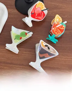 Detail of four cocktail-shaped acetate hair claws in green, red, brown and blue tones
