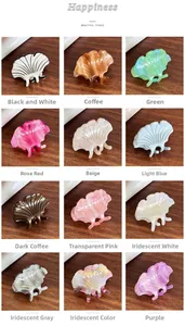 Grid view showcasing twelve ginkgo leaf shaped acetate hair clips in various marble patterns