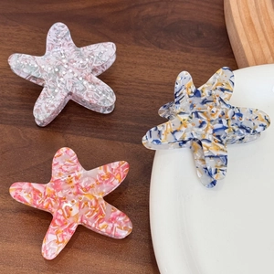 Starfish acetate hair clips with elegant marble patterns in pink, blue, and orange