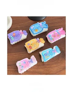 Close-up of resin hair claws in lucky bag shapes with colorful ocean themed patterns