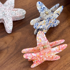 Starfish acetate hair claw clips in colorful marble patterns with subtle gold glitter