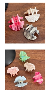 Detailed close-up of shell-shaped mini acetate hair claws in assorted pearlescent colors