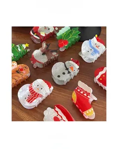Detailed view of various acrylic Christmas hair clips on a dark wood background