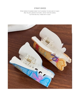 Detail of blue whale and yellow crab pattern on acetate hair claw clips for women