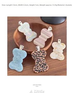 Detailed view of acetate bow hair clips with marble patterns and metal duckbill grip