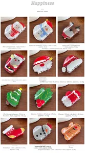Detail set of Christmas themed hair claws featuring Santa and reindeer on wooden background