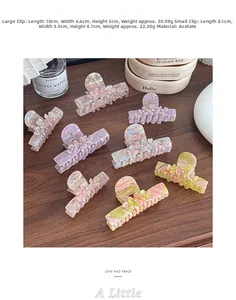 Detail view of acetate flower hair claws in multiple colors with size and weight dimensions