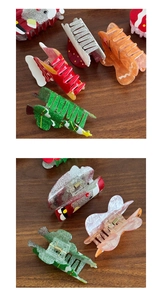 Detail of Christmas claw clips showing Santa and tree designs with metallic spring