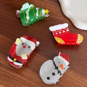 Set of four festive Christmas hair claws featuring Santa, snowman and tree designs