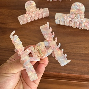 Elegant floral acetate hair claw clips with marble texture and rhinestone accents