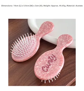 Detail showing pink acetate hair brush texture with rhinestone design and size 14cm x 5.9cm