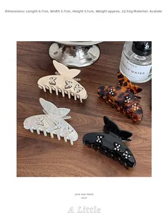 Set di mollette a farfalla in acetato nei colori crema, tartaruga, perla e nero lucido