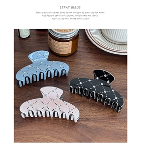 Three elegant quilted hair claws in blue, black, and pink with sparkling rhinestones