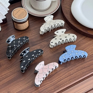 Elegant dog pattern and rhinestone claw clips set on a wooden table setup