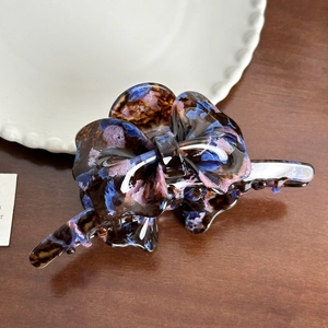 Detail of tortoiseshell acetate butterfly hair claw clip with elegant marble patterns