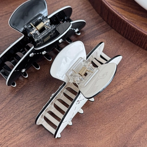 Elegant large puppy hair claw clips in black and cream with sparkling rhinestones for women
