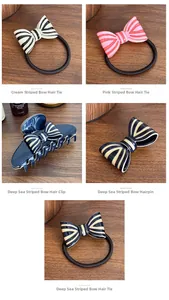 Detail of striped bow hair clips and scrunchies in cream, pink, and navy blue resin