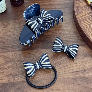 Three-piece navy blue bow hair accessories set including claw clip and hair tie