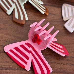 Pink and red butterfly hair claw clip with geometric stripes and 3D bow accent