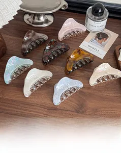 Detailed view of acetic acid geometric hair claws in marble and tortoiseshell patterns
