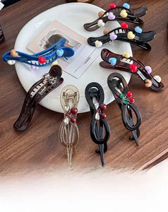 Detail of assorted Maillard hair clips including leopard bows and heart patterns